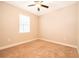 Cozy bedroom with plush carpet, a ceiling fan, and a window for natural light at 7848 Somersworth Dr, Kissimmee, FL 34747