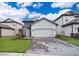 Charming single-Gathering home features a two-car garage, stone accents, and manicured front lawn at 7848 Somersworth Dr, Kissimmee, FL 34747