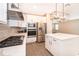 Modern kitchen features stainless steel appliances, white cabinetry and island, and wood-look flooring at 7848 Somersworth Dr, Kissimmee, FL 34747