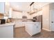 Stylish kitchen with white cabinets, a center island, and stainless steel appliances at 7848 Somersworth Dr, Kissimmee, FL 34747