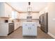 Well-lit kitchen with white cabinetry, stainless steel appliances, and a central island at 7848 Somersworth Dr, Kissimmee, FL 34747