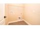 Empty laundry room featuring wood flooring and utility connections at 7848 Somersworth Dr, Kissimmee, FL 34747