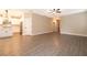 Open-concept living space with wood-look floors and access to the kitchen at 7848 Somersworth Dr, Kissimmee, FL 34747