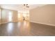 Spacious living room featuring wood-look flooring flowing into the open concept kitchen at 7848 Somersworth Dr, Kissimmee, FL 34747