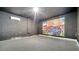 Large basement space with gray-painted brick and an eye-catching mural at 7921 Jacks Club Dr, Kissimmee, FL 34747