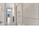 Modern bathroom featuring tiled walls, glass shower, and entry to bedroom with balcony view at 7921 Jacks Club Dr, Kissimmee, FL 34747