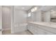 Bright bathroom with double sink vanity, soaking tub, and modern fixtures at 7921 Jacks Club Dr, Kissimmee, FL 34747