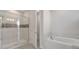 This bathroom features a tiled shower with glass doors and a luxurious soaking tub at 7921 Jacks Club Dr, Kissimmee, FL 34747
