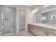 Bathroom featuring double vanity, walk-in shower, and decorative tile accents at 7921 Jacks Club Dr, Kissimmee, FL 34747