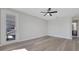 Bright bedroom featuring a ceiling fan, gray floors and a balcony door leading outside at 7921 Jacks Club Dr, Kissimmee, FL 34747
