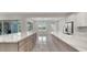 A dining room with access to the outside, featuring a large island and modern white cabinetry at 7921 Jacks Club Dr, Kissimmee, FL 34747