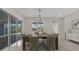A bright dining room features an elegant table setting, a view of the pool, and sliding door access to the patio at 7921 Jacks Club Dr, Kissimmee, FL 34747