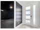 Elegant foyer with a sleek front door, a dark accent wall, and tile floors at 7921 Jacks Club Dr, Kissimmee, FL 34747