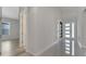 Hallway showcasing the home's wood-look floors and inviting front door with sidelights at 7921 Jacks Club Dr, Kissimmee, FL 34747
