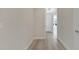 Hallway with wood flooring leading to rooms with ample natural light at 7921 Jacks Club Dr, Kissimmee, FL 34747