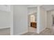 Open hallway leading to a bathroom with a wooden vanity and modern fixtures at 7921 Jacks Club Dr, Kissimmee, FL 34747