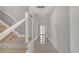 Hallway with sleek metal-and-wood staircase, modern door and glossy tile floors at 7921 Jacks Club Dr, Kissimmee, FL 34747