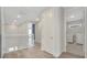 Open hallway with light wood floors that leads to bedrooms and laundry room at 7921 Jacks Club Dr, Kissimmee, FL 34747