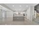 Modern kitchen with an island, stainless appliances, and access to staircase at 7921 Jacks Club Dr, Kissimmee, FL 34747