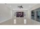 Large living area with modern tile floor, custom wall and sliding glass doors to the patio at 7921 Jacks Club Dr, Kissimmee, FL 34747