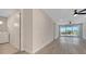Bright living room with wood floors, ceiling fans, and sliding glass doors to the balcony at 7921 Jacks Club Dr, Kissimmee, FL 34747