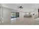 Open-concept living room flows into modern kitchen, and has sliding glass doors to the backyard at 7921 Jacks Club Dr, Kissimmee, FL 34747