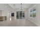 A spacious and airy living room featuring tile floors, sliding glass doors, and recessed lighting at 7921 Jacks Club Dr, Kissimmee, FL 34747
