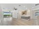 Open living area with a balcony, gray cabinets with a sink and light gray flooring at 7921 Jacks Club Dr, Kissimmee, FL 34747