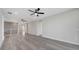 Open loft with gray flooring, recessed lighting and a large window entryway at 7921 Jacks Club Dr, Kissimmee, FL 34747