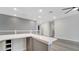 A loft with quartz countertops, gray flooring, a wet bar, and recessed lighting at 7921 Jacks Club Dr, Kissimmee, FL 34747