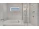 Bright bathroom with soaking tub and glass enclosed shower; a serene retreat at 7921 Jacks Club Dr, Kissimmee, FL 34747