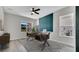 Bright home office featuring modern desk, ceiling fan and a large window for natural light at 7921 Jacks Club Dr, Kissimmee, FL 34747