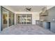 This covered patio features a full outdoor kitchen and multiple sliding glass doors at 7921 Jacks Club Dr, Kissimmee, FL 34747