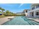 Luxury pool and spa combination with modern design, surrounded by lush landscaping at 7921 Jacks Club Dr, Kissimmee, FL 34747