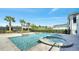 Beautiful pool and spa area surrounded by tropical landscaping with a black fence at 7921 Jacks Club Dr, Kissimmee, FL 34747