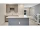 A wet bar with gray cabinets, a sink, quartz countertops, and a wine rack at 7921 Jacks Club Dr, Kissimmee, FL 34747