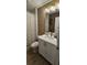 Well-maintained bathroom with a white vanity, designer mirror, and shower-tub combination at 803 Longboat Dr, Davenport, FL 33896