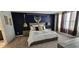 Serene bedroom featuring a large window, comfortable bed, and stylish decor at 803 Longboat Dr, Davenport, FL 33896