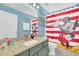 Fun bathroom with vanity and shower with Mickey Mouse curtain at 8462 Secret Key Cv, Kissimmee, FL 34747