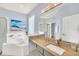 Bathroom with granite vanity, white tub, shower, large mirror and ocean artwork on the wall at 8462 Secret Key Cv, Kissimmee, FL 34747
