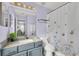 Bright bathroom with lilac walls, vanity with granite counters, and shower with butterfly curtain at 8462 Secret Key Cv, Kissimmee, FL 34747