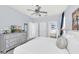 A bright bedroom featuring a ceiling fan and a dresser with a television on top at 8462 Secret Key Cv, Kissimmee, FL 34747
