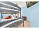 bedroom with grey bunk beds and blue walls plus TV at 8462 Secret Key Cv, Kissimmee, FL 34747