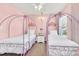 Pink bedroom with two princess themed twin beds at 8462 Secret Key Cv, Kissimmee, FL 34747