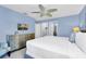 Bright bedroom featuring light blue walls, a ceiling fan and a TV at 8462 Secret Key Cv, Kissimmee, FL 34747