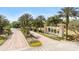 The grand entrance to Emerald Island Resort is framed by lush landscaping and stately columns, with welcoming signage at 8462 Secret Key Cv, Kissimmee, FL 34747