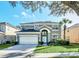 Charming two-story home with a well-manicured lawn and attached two-car garage at 8462 Secret Key Cv, Kissimmee, FL 34747
