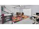 Spacious garage featuring an air hockey table and a basketball hoop at 8462 Secret Key Cv, Kissimmee, FL 34747
