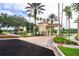 Controlled access into the community featuring a gatehouse, security gate, and beautiful landscaping at 8462 Secret Key Cv, Kissimmee, FL 34747