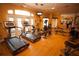 Bright fitness center with treadmills, ellipticals, weights, and ample workout space in a well-lit community gym at 8462 Secret Key Cv, Kissimmee, FL 34747